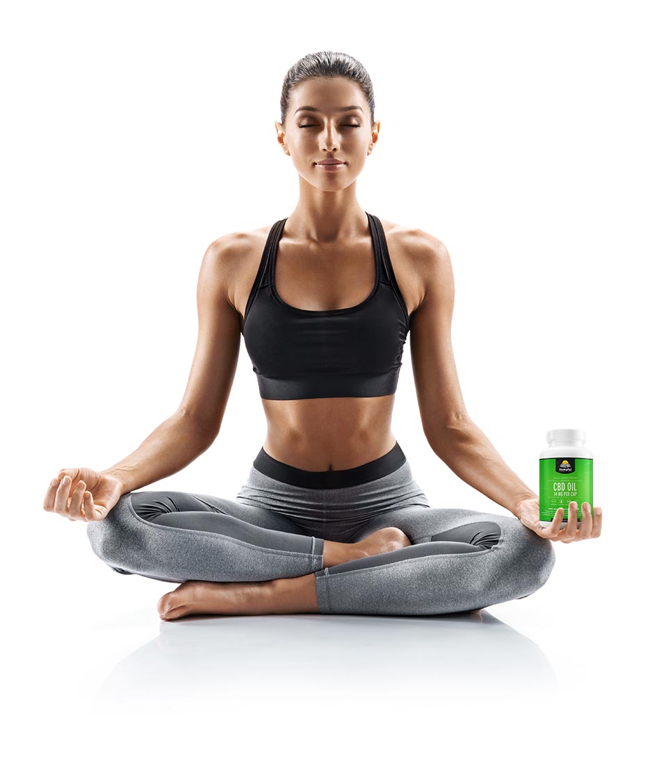 healthy woman in yoga pose holding cbd oils